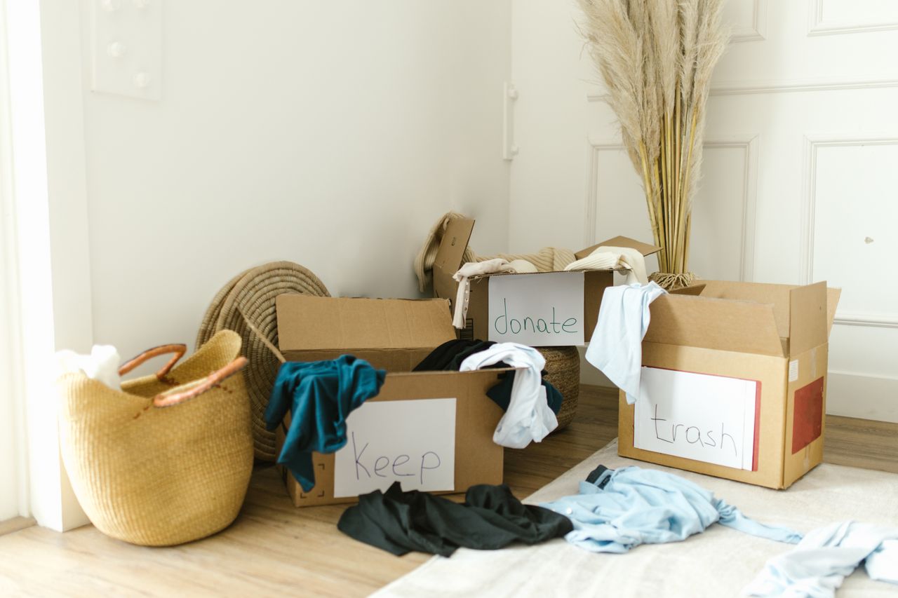 Cardboard boxes marked Keep, Donate, and Trash for decluttering the home.